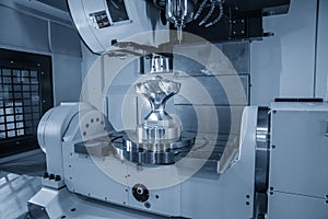 The five axis machining center cutting the mechanical parts with the solid ball endmill tools. photo