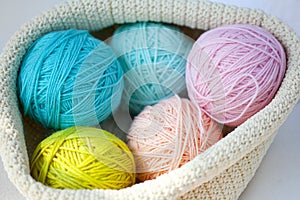 Five balls of wool - blue, light blue, yellow, pink and pale pink