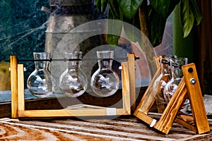 Five beakers on wood frames