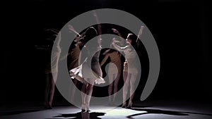 Five beautiful girls start dancing modern contemporary dance, on black, shadow, slow motion
