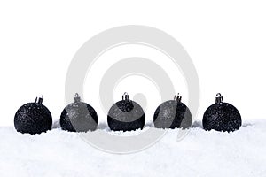 Five Black christmas balls with snow on white background
