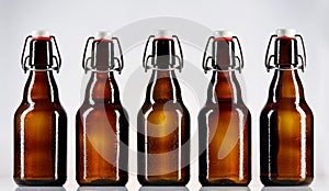 Five blank glass bottles of beer