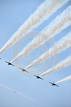 Five blue angel jets flying overhead in sync