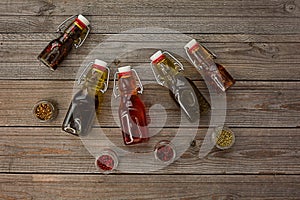 Five bottles of freshly-flavored olive oil with spices