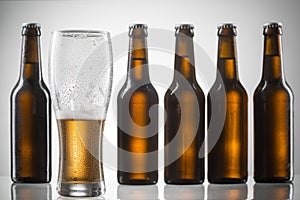 Five bottles and half-empty glass