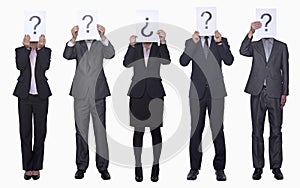 Five business people holding up paper with question mark, obscured face, studio shot