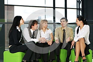 Five business persons are having a conversation