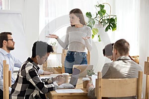 Five businesspeople discussing at seminar in conference room