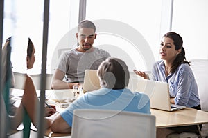 Five Businesspeople Having Meeting In Boardroom