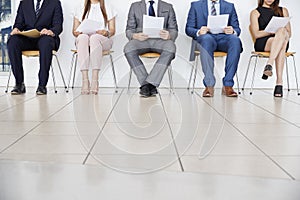 Five candidates waiting for job interviews, front view, crop