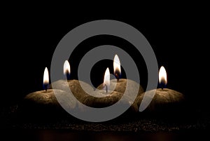 Five candles on a black background