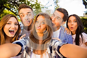 Five cheerful fooling best friends making selfie photo and having fun