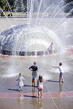 Five Children looking at and Playing in Seattle Fountain