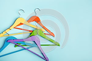 Five children's hangers for clothes of rainbow colors.