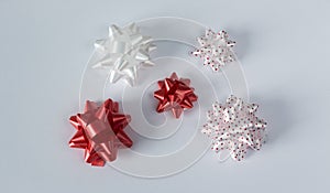 Five colored bows on gift on white background