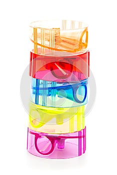 Five colorful plastic pencil sharpeners on white background