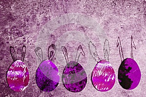 Five decorative colorful - pink, purple, black, paper eggs with drawn bunny ears