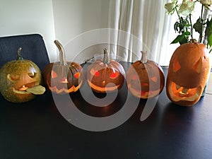 Five different pumpkins with tealights