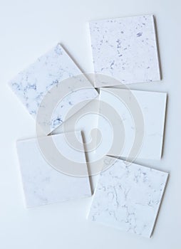 Five different stone samples mainly white based with marble like grains and veins