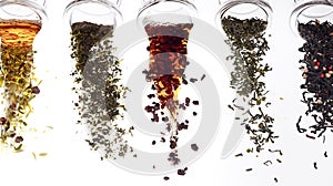 Five different types of tea spilling from glass jars against a white background, highlighting various colors and blends