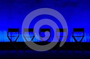 Five Director's Chairs silhouette on Blue Stage