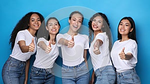 Five Diverse Girls Gesturing Thumbs Up Smiling, Blue Background, Panorama