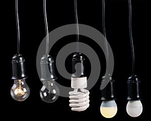 Five electric lamps in receptacle on black