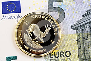 A five Euro bank note with a gold South African Krugerrand