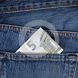 Five Euro banknote in trouser pocket photo