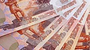 Five five-thousand-dollar bills lie in a fan. Banknotes of 5000 rubles. The Russian national currency. Background of money. Cash