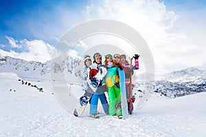 Five friends standing with snowboards