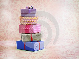 Five gift boxes with pink background