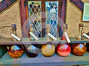 Five glass flacons with decoction of natural herbs in the medieval town