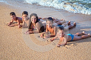 Five happy kids on the beach