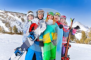 Five happy smiling friends with snowboards