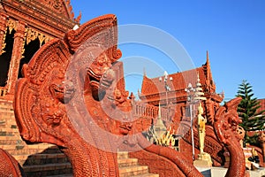 Five head snake sculpture and gold buddha statue