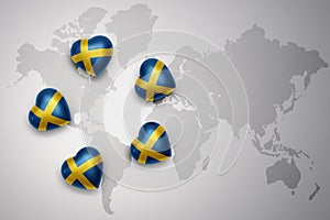 five hearts with national flag of sweden on a world map background.