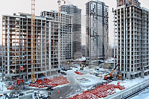 Five high buildings under construction with cranes