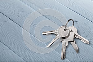 Five house keys on wooden background