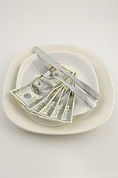 Five hundred dollar bills on a plate