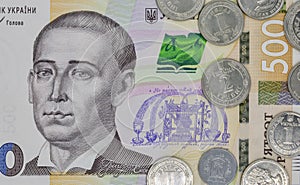 Five hundred ukrainian hryvna banknote and coins closeup