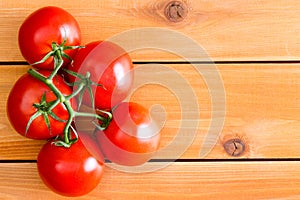 Five Hydroponic tomatoes over plain wooden table