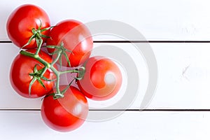 Five Hydroponic tomatoes over white wooden table