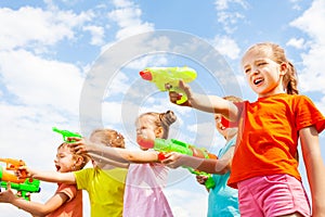 Five kids play with water guns