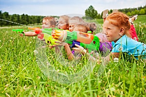 Five kids play with water guns