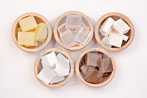 Five kinds of glycerin soap bases in wooden bowls photo