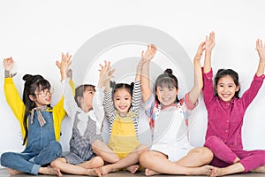 Five little girls raising their hands photo