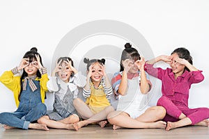 Five little girls raising their hands