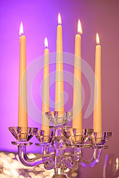 Five long burning candles set in a beautiful crystal candle holder with five scalloped bobeche