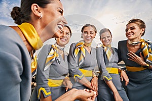 Five lovely air hostesses having a good time outdoors